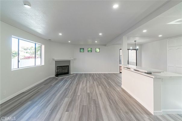 Empty room, Fireplace, Interior, Kitchen, Pendant Lights, Recessed Lighting, Wood Texture Flooring