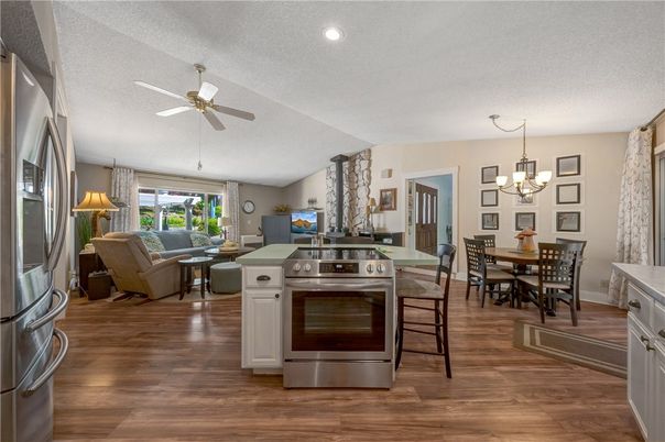 Chandelier, Dining room, Interior, Kitchen, Living room, Recessed Lighting, Stainless Steel Appliances, Wood Texture Flooring