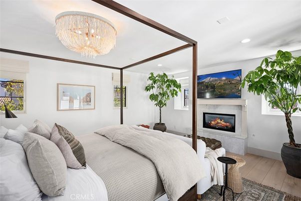 Bedroom, Chandelier, Fireplace, Interior, Recessed Lighting, Wood Texture Flooring