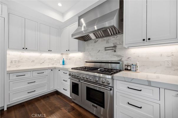 Interior, Kitchen, Marble Walls, Recessed Lighting, Stainless Steel Appliances, Wood Texture Flooring