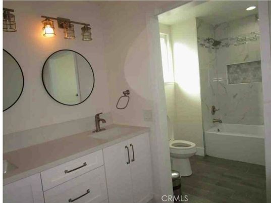 Bathroom, Dual Sink Vanities, Interior, Marble Walls, Recessed Lighting, Wood Texture Flooring