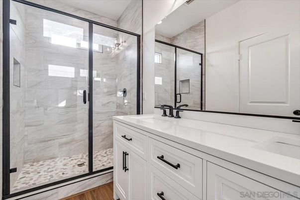 Bathroom, Dual Sink Vanities, Glass Shower, Interior, Marble Walls, Wood Texture Flooring