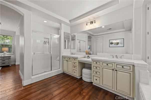 Bathroom, Dual Sink Vanities, Glass Shower, Interior, Recessed Lighting, Tile Countertops, Wood Texture Flooring