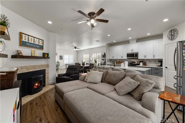 Dining room, Fireplace, Interior, Kitchen, Living room, Recessed Lighting, Stainless Steel Appliances, Wood Texture Flooring