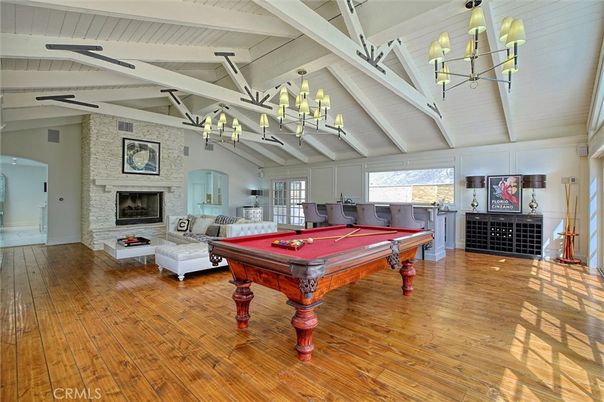 Billiard Table, Chandelier, Fireplace, Game Room, Interior, Living room, Stone Walls, Wood Texture Flooring