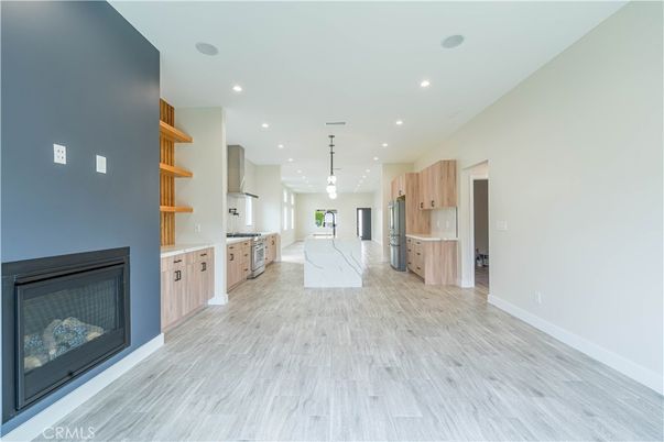 Fireplace, Interior, Kitchen, Pendant Lights, Recessed Lighting, Stainless Steel Appliances, Wood Texture Flooring