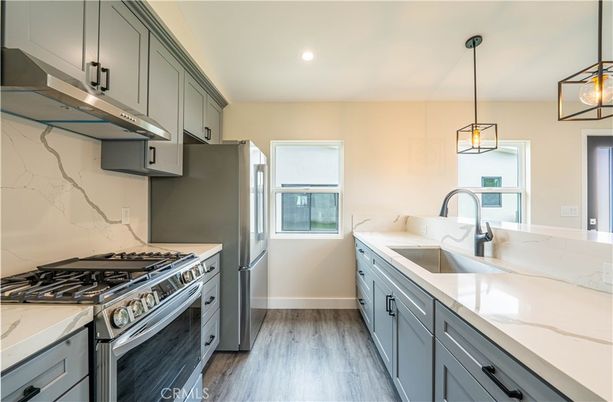 Interior, Kitchen, Marble Walls, Pendant Lights, Recessed Lighting, Stainless Steel Appliances, Wood Texture Flooring