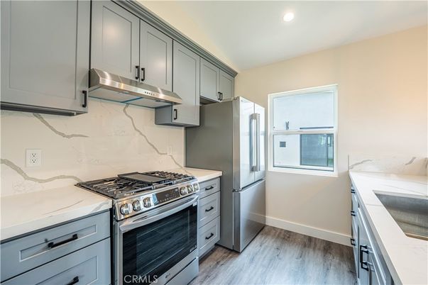 Interior, Kitchen, Marble Walls, Recessed Lighting, Stainless Steel Appliances, Wood Texture Flooring