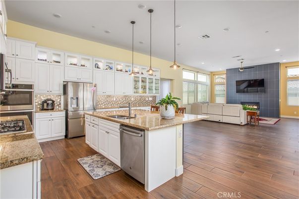 Fireplace, Interior, Kitchen, Living room, Pendant Lights, Recessed Lighting, Stainless Steel Appliances, Wood Texture Flooring