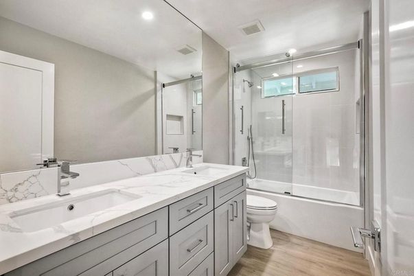 Bathroom, Dual Sink Vanities, Glass Shower, Interior, Recessed Lighting, Wood Texture Flooring