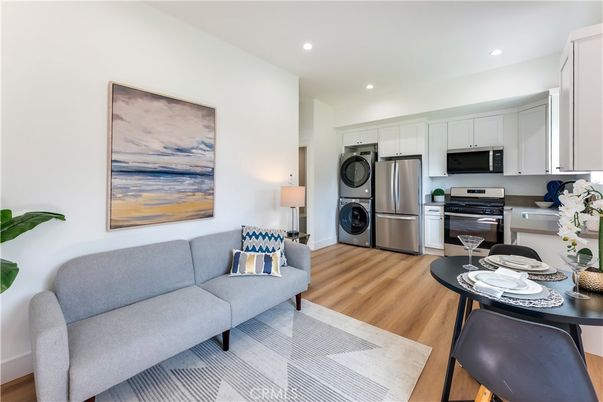Dining room, Interior, Kitchen, Living room, Recessed Lighting, Stainless Steel Appliances, Washer, Wood Texture Flooring