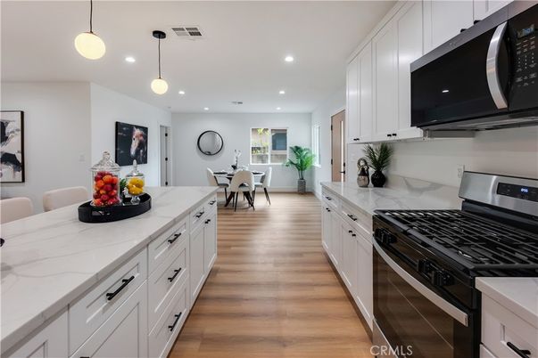 Dining room, Interior, Kitchen, Pendant Lights, Recessed Lighting, Stainless Steel Appliances, Wood Texture Flooring