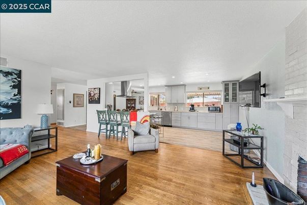 Dining room, Fireplace, Interior, Kitchen, Living room, Recessed Lighting, Stainless Steel Appliances, Stone Walls, Wood Texture Flooring