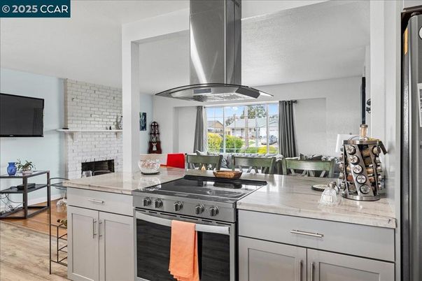 Dining room, Fireplace, Interior, Kitchen, Stainless Steel Appliances, Stone Walls, Wood Texture Flooring
