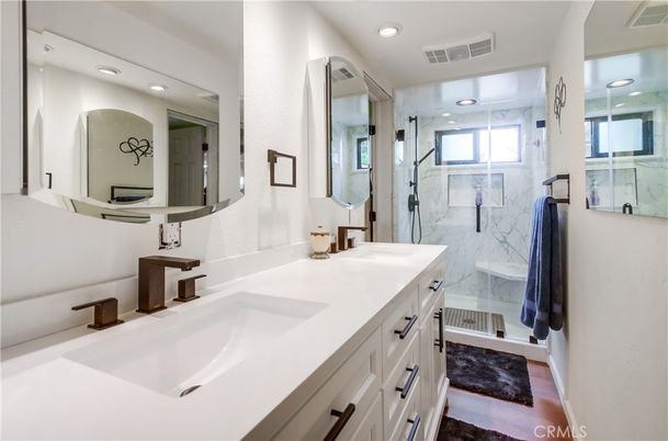 Bathroom, Dual Sink Vanities, Glass Shower, Interior, Marble Walls, Recessed Lighting, Wood Texture Flooring