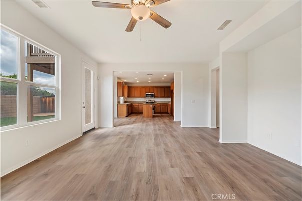 Empty room, Interior, Kitchen, Recessed Lighting, Stainless Steel Appliances, Wood Texture Flooring