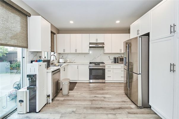 Interior, Kitchen, Marble Walls, Recessed Lighting, Stainless Steel Appliances, Wood Texture Flooring