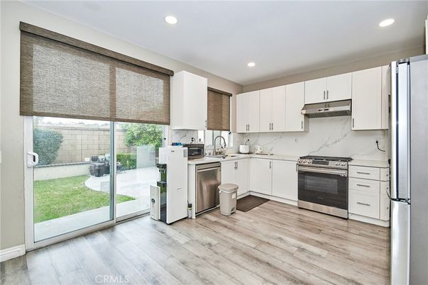 Interior, Kitchen, Marble Walls, Recessed Lighting, Stainless Steel Appliances, Wood Texture Flooring