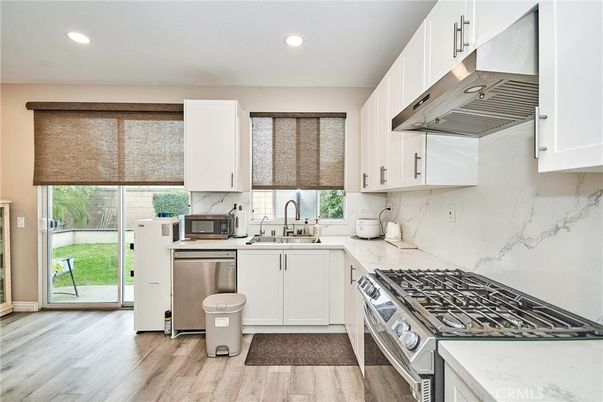Interior, Kitchen, Marble Walls, Recessed Lighting, Stainless Steel Appliances, Wood Texture Flooring