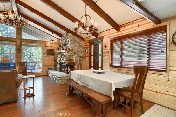 Chandelier, Dining room, Fireplace, Interior, Living room, Pendant Lights, Stone Walls, Wooden Beams, Wood Texture Flooring, Wooden Walls