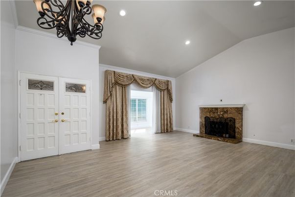 Chandelier, Empty room, Fireplace, Interior, Recessed Lighting, Wood Texture Flooring