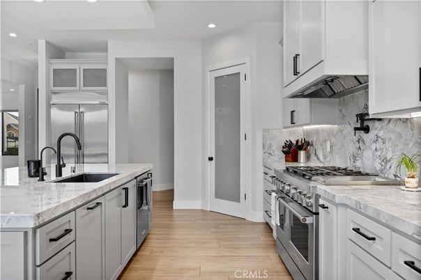 Interior, Kitchen, Marble Walls, Recessed Lighting, Stainless Steel Appliances, Wood Texture Flooring