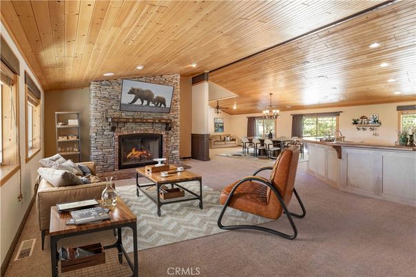 Chandelier, Dining room, Fireplace, Interior, Living room, Recessed Lighting, Stone Walls, Wooden Ceilings