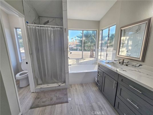 Bathroom, Dual Sink Vanities, Free Standing Baths, Interior, Marble Walls, Wood Texture Flooring