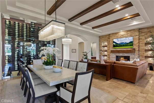 Chandelier, Dining room, Fireplace, Interior, Living room, Recessed Lighting, Stone Walls, Wine Storage, Wooden Beams