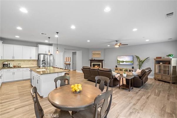 Dining room, Fireplace, Interior, Kitchen, Living room, Pendant Lights, Recessed Lighting, Stainless Steel Appliances, Wood Texture Flooring
