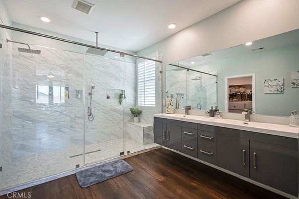 Bathroom, Dual Sink Vanities, Glass Shower, Interior, Marble Walls, Recessed Lighting, Wood Texture Flooring