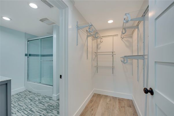 Bathroom, Glass Shower, Interior, Recessed Lighting, Walk-in Closets, Wood Texture Flooring