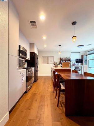 Dining room, Interior, Kitchen, Pendant Lights, Recessed Lighting, Stainless Steel Appliances, Wood Texture Flooring