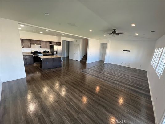 Empty room, Interior, Kitchen, Recessed Lighting, Stainless Steel Appliances, Wood Texture Flooring