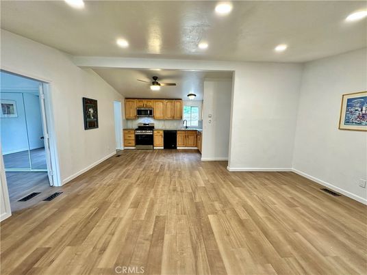 Empty room, Interior, Kitchen, Recessed Lighting, Stainless Steel Appliances, Wood Texture Flooring