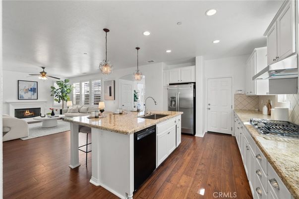 Fireplace, Interior, Kitchen, Living room, Pendant Lights, Recessed Lighting, Stainless Steel Appliances, Wood Texture Flooring