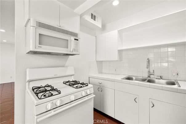 Interior, Kitchen, Recessed Lighting, Tile Countertops, Wood Texture Flooring