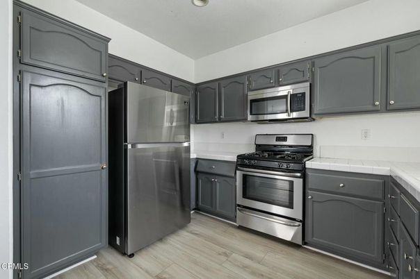 Interior, Kitchen, Recessed Lighting, Stainless Steel Appliances, Tile Countertops, Wood Texture Flooring