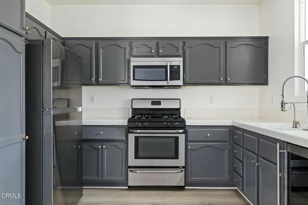Interior, Kitchen, Stainless Steel Appliances, Tile Countertops, Wood Texture Flooring