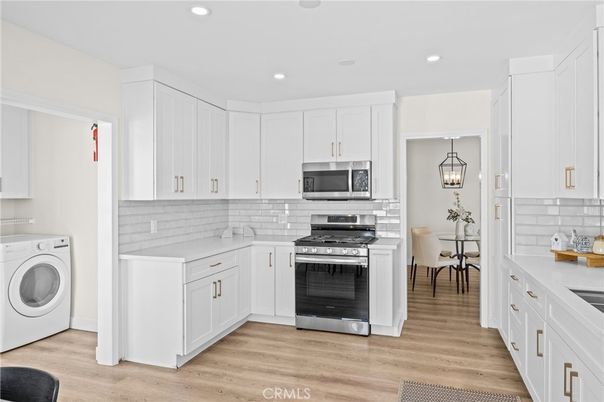 Dining room, Interior, Kitchen, Pendant Lights, Recessed Lighting, Stainless Steel Appliances, Washer, Wood Texture Flooring