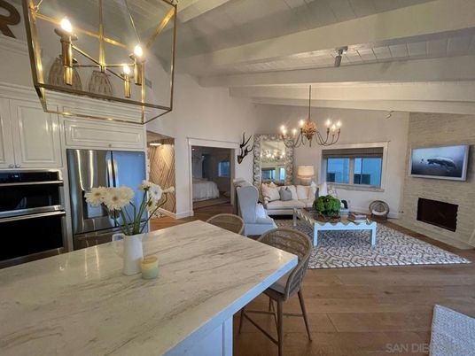 Chandelier, Dining room, Fireplace, Interior, Kitchen, Living room, Pendant Lights, Stainless Steel Appliances, Stone Walls, Wood Texture Flooring
