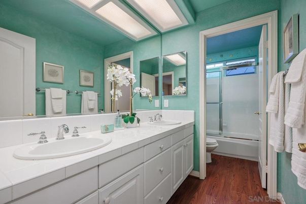 Bathroom, Dual Sink Vanities, Glass Shower, Interior, Tile Countertops, Wood Texture Flooring