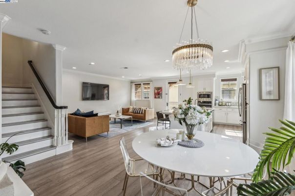 Chandelier, Dining room, Interior, Kitchen, Living room, Pendant Lights, Recessed Lighting, Stainless Steel Appliances, Wood Texture Flooring