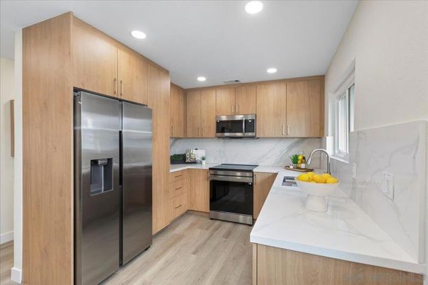 Interior, Kitchen, Marble Walls, Recessed Lighting, Stainless Steel Appliances, Wood Texture Flooring