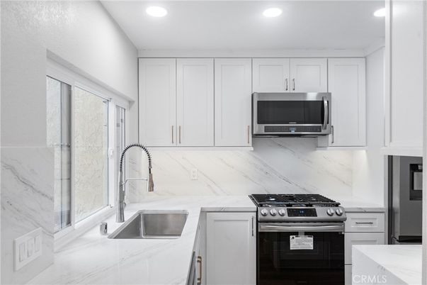 Interior, Kitchen, Marble Walls, Recessed Lighting, Stainless Steel Appliances