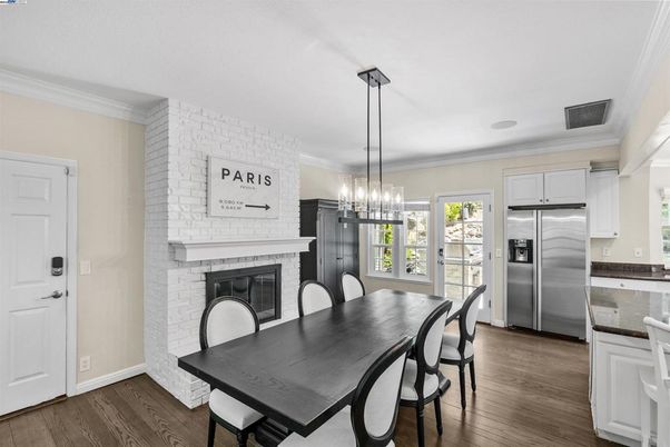 Dining room, Fireplace, Interior, Kitchen, Pendant Lights, Stainless Steel Appliances, Stone Walls, Wood Texture Flooring