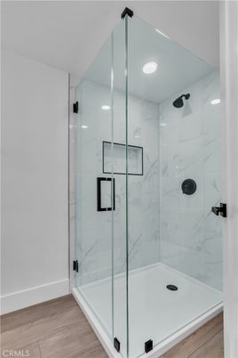 Bathroom, Glass Shower, Interior, Marble Walls, Recessed Lighting, Wood Texture Flooring