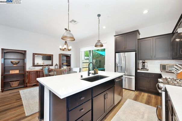 Dining room, Interior, Kitchen, Pendant Lights, Recessed Lighting, Stainless Steel Appliances, Wood Texture Flooring
