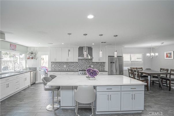 Chandelier, Dining room, Interior, Kitchen, Pendant Lights, Recessed Lighting, Stainless Steel Appliances, Wood Texture Flooring