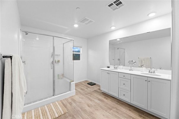Bathroom, Dual Sink Vanities, Glass Shower, Interior, Recessed Lighting, Wood Texture Flooring